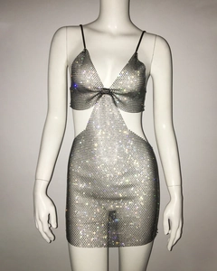 Close-up of silver rhinestone fishnet dress with side cut-outs and metallic mesh texture