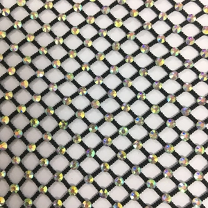 Macro view of black mesh fabric with sparkling AB rhinestones on the diamond pattern