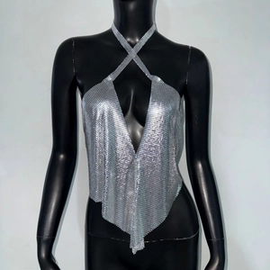 Detail of silver metallic sequin halter top with crisscross neck and V-neckline