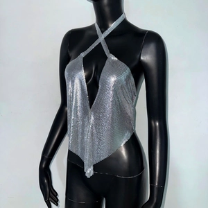 Close-up of silver sequin halter top featuring metallic chainmail and V-neckline detail
