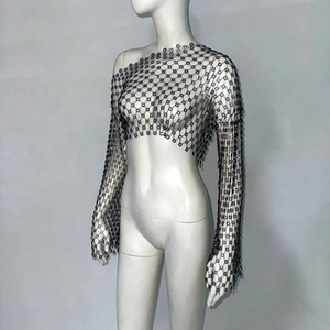 Close-up of black cutout fishnet top with shimmering rhinestones and one-shoulder cut