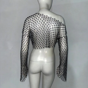 Detailed view of floral mesh knit texture with sparkling rhinestones on black long sleeve top