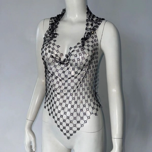 Close-up of black mesh vest featuring intricate floral knit pattern and V-shaped hemline