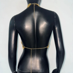 Detail of gold metal choker and back chain tassel on black mannequin for festivals
