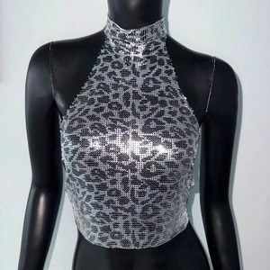 Detail of leopard print metal mesh halter top featuring shiny sequins for music festivals