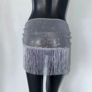 Détail d'une jupe en résille argentée à franges et strass brillants sur mannequin
