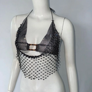 Gros plan sur un haut licou en résille noire avec strass brillants et boucle en écaille