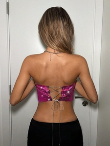 Rückansicht des pinkfarbenen Pailletten-Crop-Tops mit gekreuzten Metallketten