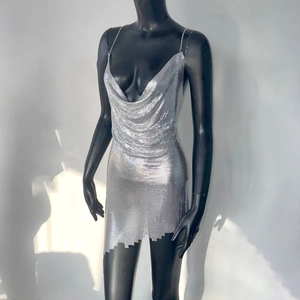 Detailed macro view of silver metal mesh texture and delicate chain strap on mini dress