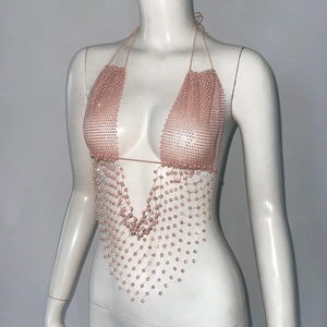 Close-up of pink crystal mesh halter top featuring intricate beadwork for music festivals