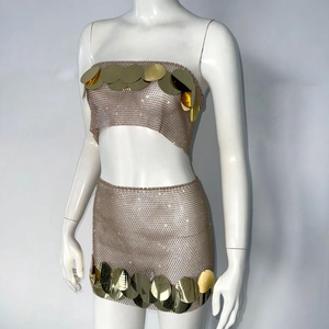 Macro detail of rose gold mesh fabric and large golden paillette sequins on the party set