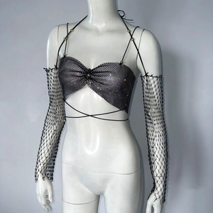 Detail of black rhinestone fishnet top and sleeves with sparkling crystal mesh texture