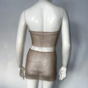Back view of gold chainmail two-piece set with shimmering rhinestones on a mannequin