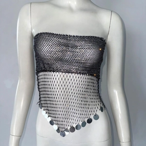 Detail of black fishnet crop top with rhinestones and hanging silver sequins