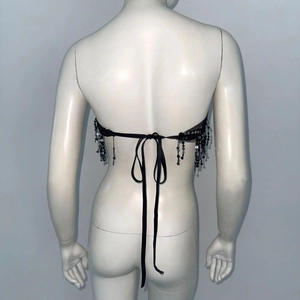 Black sequin corset top with beaded tassels and lace-up back for festival wear