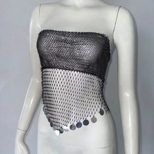 Macro shot of black sequin mesh top with sparkling silver rhinestones and metal disc fringe
