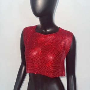 Close-up of red rhinestone crop top featuring shimmering crystals and mesh texture