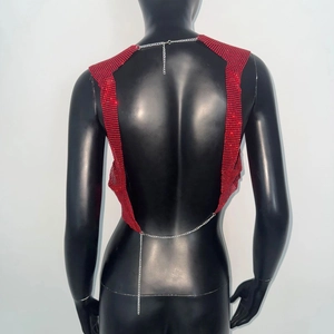 Close-up of red sequin halter top with open back and adjustable silver metal chains