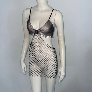 Detailed view of sexy mesh rhinestone dress with black metal rings and large sequins