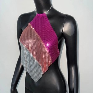 Macro view of metallic sequins in pink gold and silver on a halter crop top