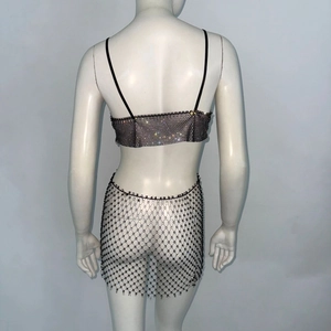 Detail of sparkly rhinestone mesh crop top and mini skirt set on a white mannequin