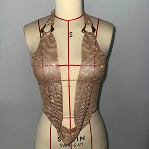 Détail du haut dos nu en maille de strass dorés avec anneaux pour festivals