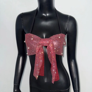 Detail of red rhinestone bow top with pearl accents and adjustable halter straps