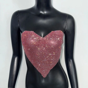 Detail of deep red heart-shaped tube top with dense rhinestones on a black mannequin