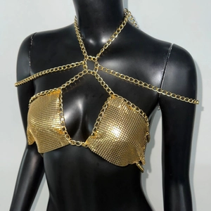 Macro shot of gold metal mesh sequins and thick chain details on a body chain top