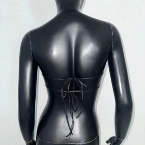 Detail of the tie-back design on a black satin heart-shaped tube top with thin straps