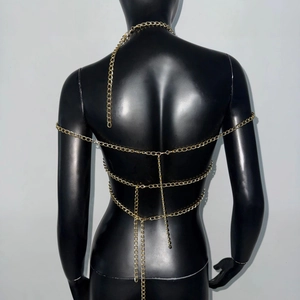 Detailed view of layered gold metal body chain with back draping and collar connector