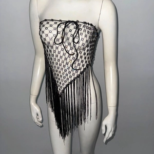 Detail of black fishnet top featuring iridescent beads and long fringe tassels for parties