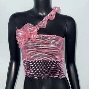 Detail of pink beaded one-shoulder top with rhinestone tassels and a large bow