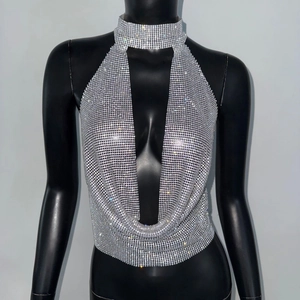 Detail of silver sequin halter top featuring a deep V-neck and integrated choker collar