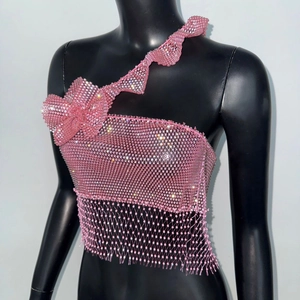 Detailed view of pink sequin crop top featuring ruffle shoulder and beaded fringe