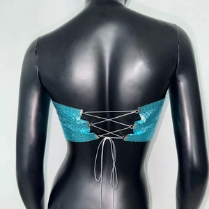 Detailed view of lake blue metallic mesh crop top featuring lace-up back design