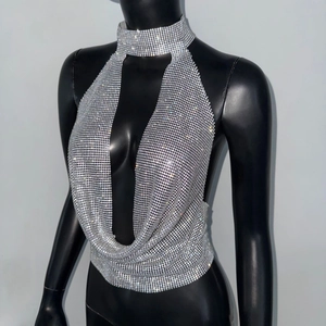 Detail view of silver rhinestone mesh halter top with shimmering metal choker neckline