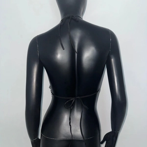 Detailed back view of a black halter top with crisscross straps and rhinestone fishnet texture
