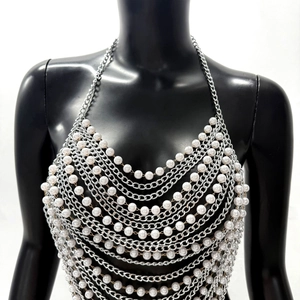 Detail showing layered pearl and silver aluminum chain link body chain on mannequin