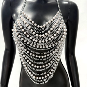 Detail of multilayer silver chain vest with white pearls for music festivals