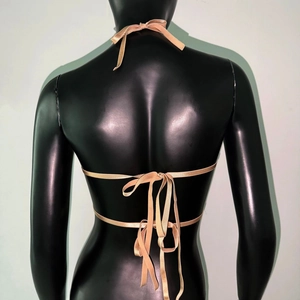 Detail of champagne satin bikini top featuring intricate triple bow tie back closure