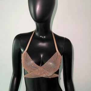 Detailed close-up of a sexy halter top featuring rhinestone mesh and wrap-around ties