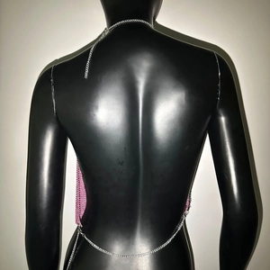 Detail view of pink metal sequin halter top with silver chain straps and backless design