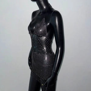 Detail of black fishnet dress with sparkling rhinestones and halter neck design