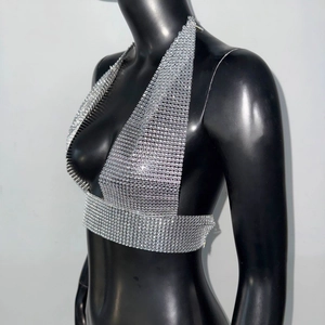 Detail of silver rhinestone mesh halter top showing sparkling crystal grid and metal texture