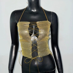 Close-up of gold sequin halter top with cross-tie design and sparkling mesh texture