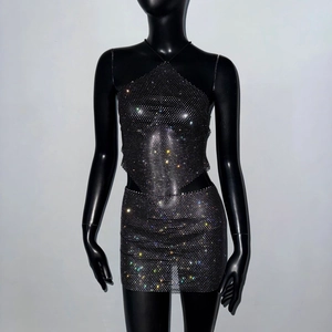 Close-up of black mesh two-piece set with shimmering rhinestones and halter neck design