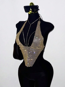 Detailed view of shimmering gold rhinestone halter top with intricate mesh pattern