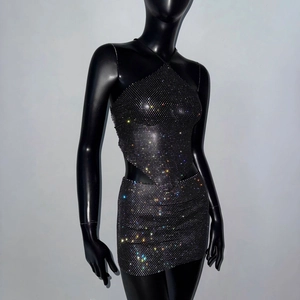 Detailed view of women's two-piece rhinestone set with crop top and mini skirt in black fabric