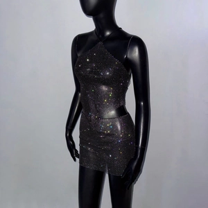 Close-up of black mesh rhinestones on crop top and mini skirt set for party